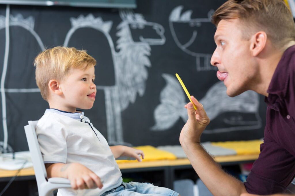 A Speech-Language Pathologist guiding a child through sound.